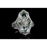 A 14ct white gold, aquamarine and diamond dress ring, set with four interlocking faceted polygons of