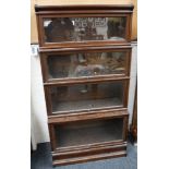 A pair of oak, four tier Globe Wernicke bookcases, raised on plinth bases.