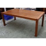 A rectangular fruitwood table, the top consisting of pierced and tennon joint design, raised on