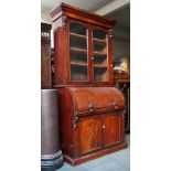 A 19th century mahogany cylinder bureau bookcase, glazed upper section and a base with end boards