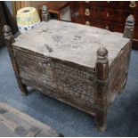 An Eastern carved softwood chest, late 19th century. The divided hinged lid above an entwined