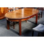 A mahogany extending oval dining table, gadrooned edge over square section legs (1 x extra leaf).