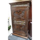A late 19th century / early 20th century oak hall closet with spindle decorated door with ornately