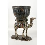 A cold painted bronze planter, globular pot being 'transported' by a camel, 37cm high.