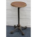 A late 19th century mahogany  wine table, raised on a cast iron pedestal on a quatreform base.
