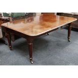A Victorian mahogany dining table, two leaves, sliding Nettlefold mechanism, tapering reed legs,