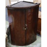 Mid 19th century bow corner cabinet, mahogany, brass handles and escutcheons, 92cm high.