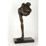 A modernish style bronze of partial torso, supported by single arm, marble base, 61cm high.