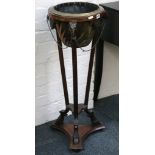 A regency style mahogany jardiniere stand, with goat mash decoration, on square section legs