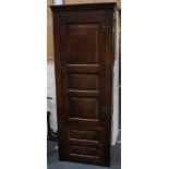 An antique Jacobean oak cupboard with moulded cornice, the door with three oblong fielded panels,