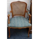 A pair of late Louis 16 style open armchairs, with caned panel backs, upholstered seats and