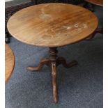 A Georgian mahogany snap top table, circular, turned column, tri-pad feet, 76.7cm diameter. A 19th