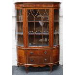 An Edwardian satinwood and crossbanded bowfront display cabinet, 1910, the moulded cornice above a
