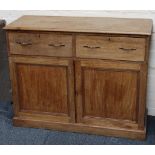 A bleached mahogany dresser with two drawers over two cupboards, raised on plinth.