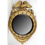 A 19th century giltwood convex wall mirror with eagle pediment.  Restored by vendor. Diameter: 62cm.