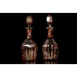 A PAIR OF BOHEMIAN AMBER STAINED ENGRAVED GLASS DECANTERS AND STOPPERS, late 19th or early 20th