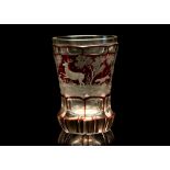 A BOHEMIAN PART RUBY STAINED AND ENGRAVED BEAKER, late 19th century, of flared faceted form, the