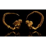 A PAIR OF HELLENISTIC GOLD EARRINGS Circa 3rd-2nd Century B.C. Each with a figure of winged Eros,