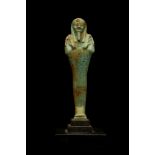 AN EGYPTIAN GREEN GLAZED COMPOSITION SHABTI Late Period, 30th Dynasty, circa 400-350 B.C. The