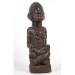 A KONGO MATERNITY FIGURE, DEMOCRATIC REPUBLIC OF CONGO The mother sitting cross-legged holding the