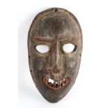 A SUKUMA MASK, TANZANIA With a wide smile and visible rows of teeth, with remains of red and black