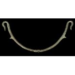 A ROMAN BRONZE VESSEL HANDLE Circa 2nd-3rd Century A.D. Of arching shape, the two hook terminals