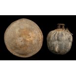 TWO HIDE ARTEFACTS, SOMALIA Including a round hide shield, the handle attached at the back, 47cm