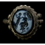 A ROMAN SILVER AND NICOLO INTAGLIO RING FRAGMENT Circa 1st-2nd Century A.D. Engraved with a seated