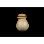 AN EGYPTIAN CALCITE MINIATURE VESSEL Early Dynastic Period, circa 3100 B.C. With hemispherical