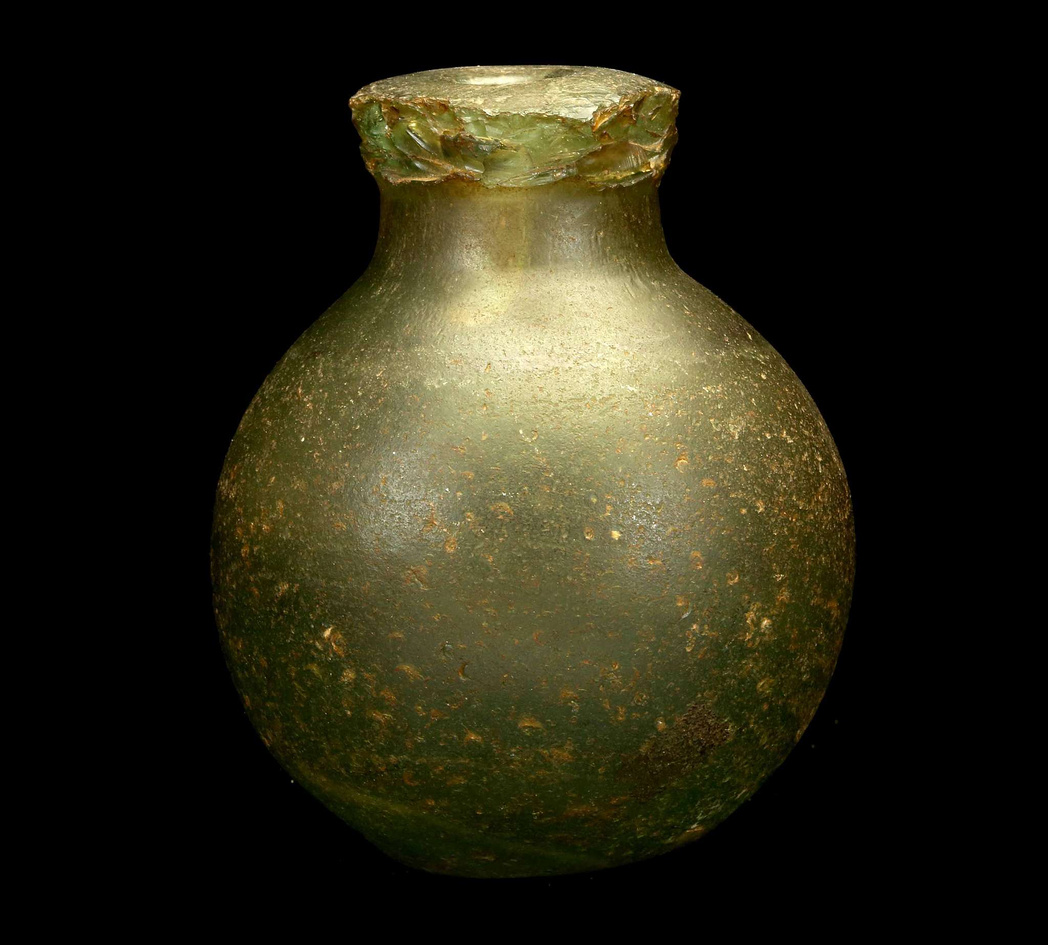 A EUROPEAN GREEN GLASS 'GREEK FIRE' HAND GRENADE Circa 16th-18th Century A.D. With thick-walled