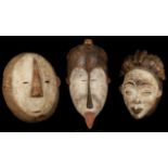 THREE AFRICAN MASKS Including a Punu 'Okuyi' mask, Gabon, 30cm high; a Fang 'Ngil' mask and a