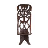 A HARDWOOD BIRTHING CHAIR, MALAWI Composed of two separate pieces, the high openwork back carved