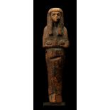 AN EGYPTIAN WOOD SHABTI New Kingdom, Ramesside Period, 19th Dynasty, circa 1295-1070 B.C. The