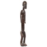 A DOGON STANDING MALE FIGURE, MALI With elongated features, the short beard with incised details,