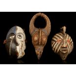 THREE AFRICAN MASKS Including a Pende 'Mbangu' distorted mask, Democratic Republic of Congo, 34cm