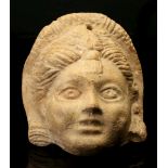 A ROMAN TERRACOTTA HOLLOW-BACKED MASK Circa 1st-2nd Century A.D. Possibly representing a new