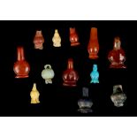 ELEVEN EGYPTIAN HARDSTONE, GLASS AND GLAZED COMPOSITION POPPY SEED-POD PENDANTS New Kingdom, circa