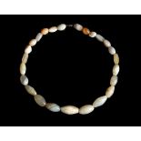 AN ANCIENT NEAR EASTERN BANDED AGATE BEAD NECKLACE Circa 2nd Millennium B.C. Restrung, composed of