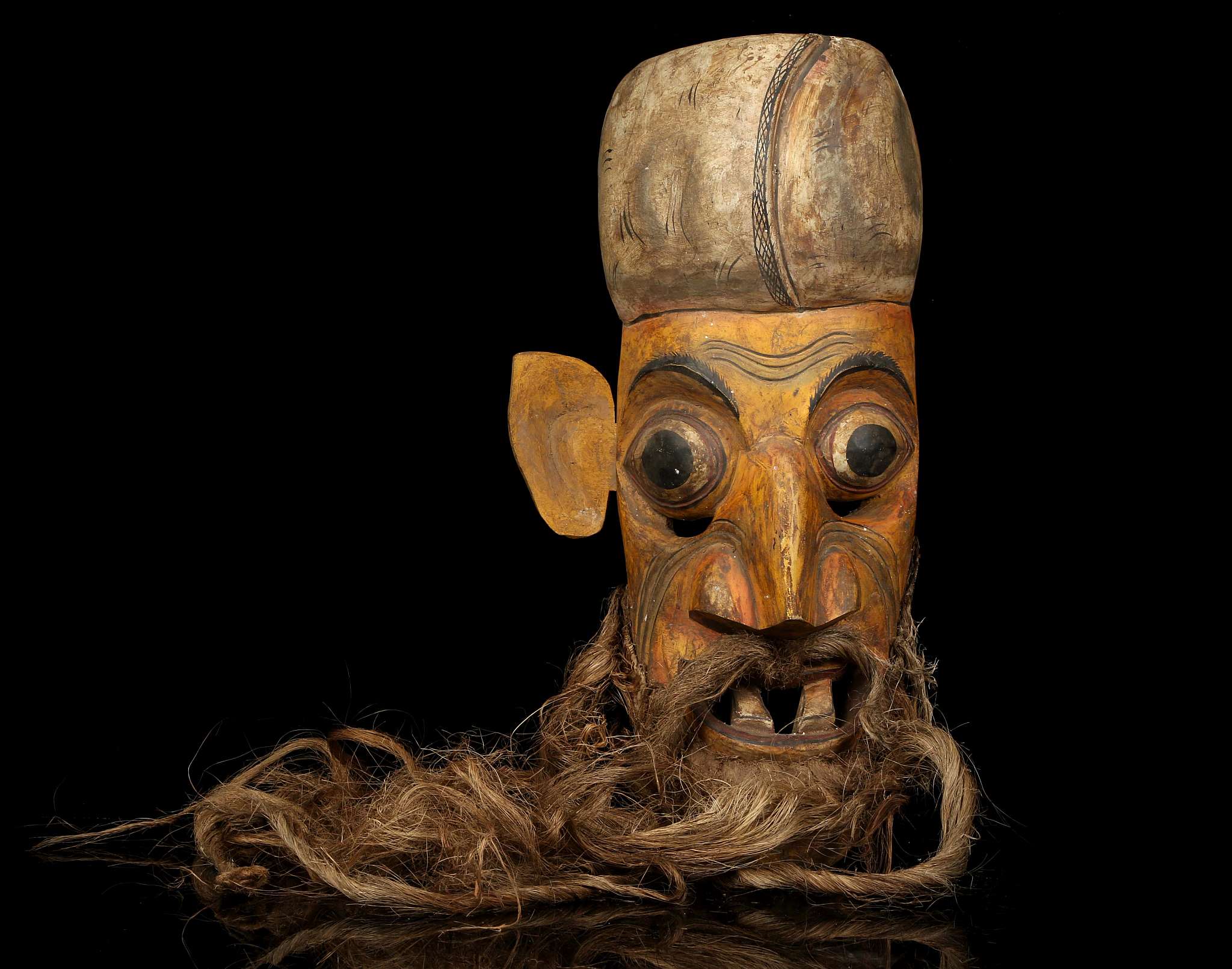 A 'KOLAM' MASK, SRI LANKA Possibly depicting the old Anabera Kolama, with long beard and open