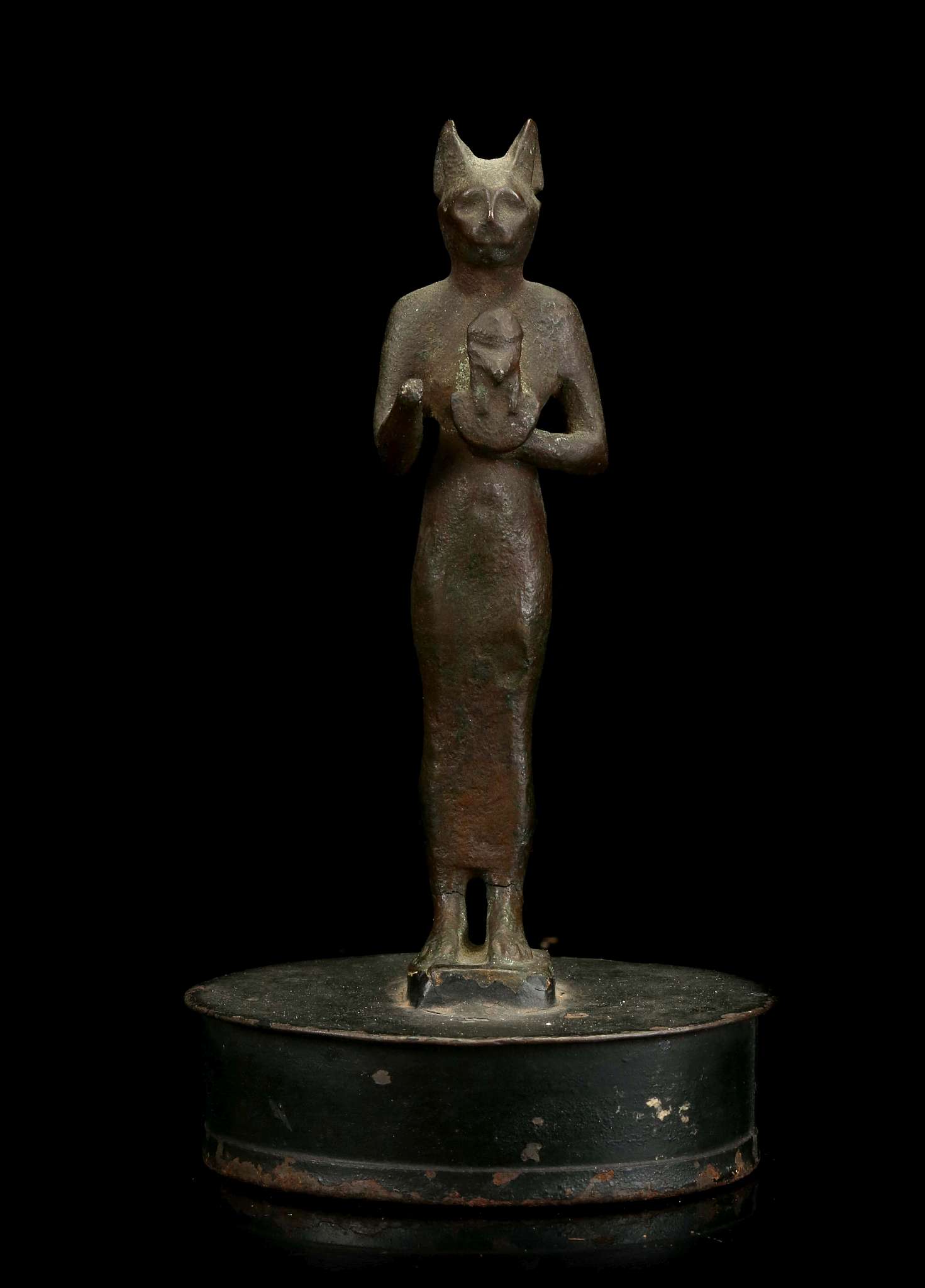 AN EGYPTIAN BRONZE FIGURE OF BASTET Late Period, circa 664-332 B.C. The cat-headed goddess