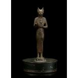 AN EGYPTIAN BRONZE FIGURE OF BASTET Late Period, circa 664-332 B.C. The cat-headed goddess
