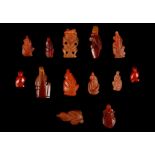 THIRTEEN EGYPTIAN CARNELIAN AND RED JASPER AMULETIC PENDANTS New Kingdom to Late Period, circa