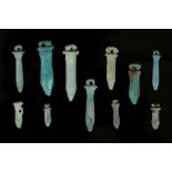 ELEVEN EGYPTIAN GLAZED COMPOSITION AND HARDSTONE PAPYRUS SCEPTRE AMULETS Late Period, circa 664-