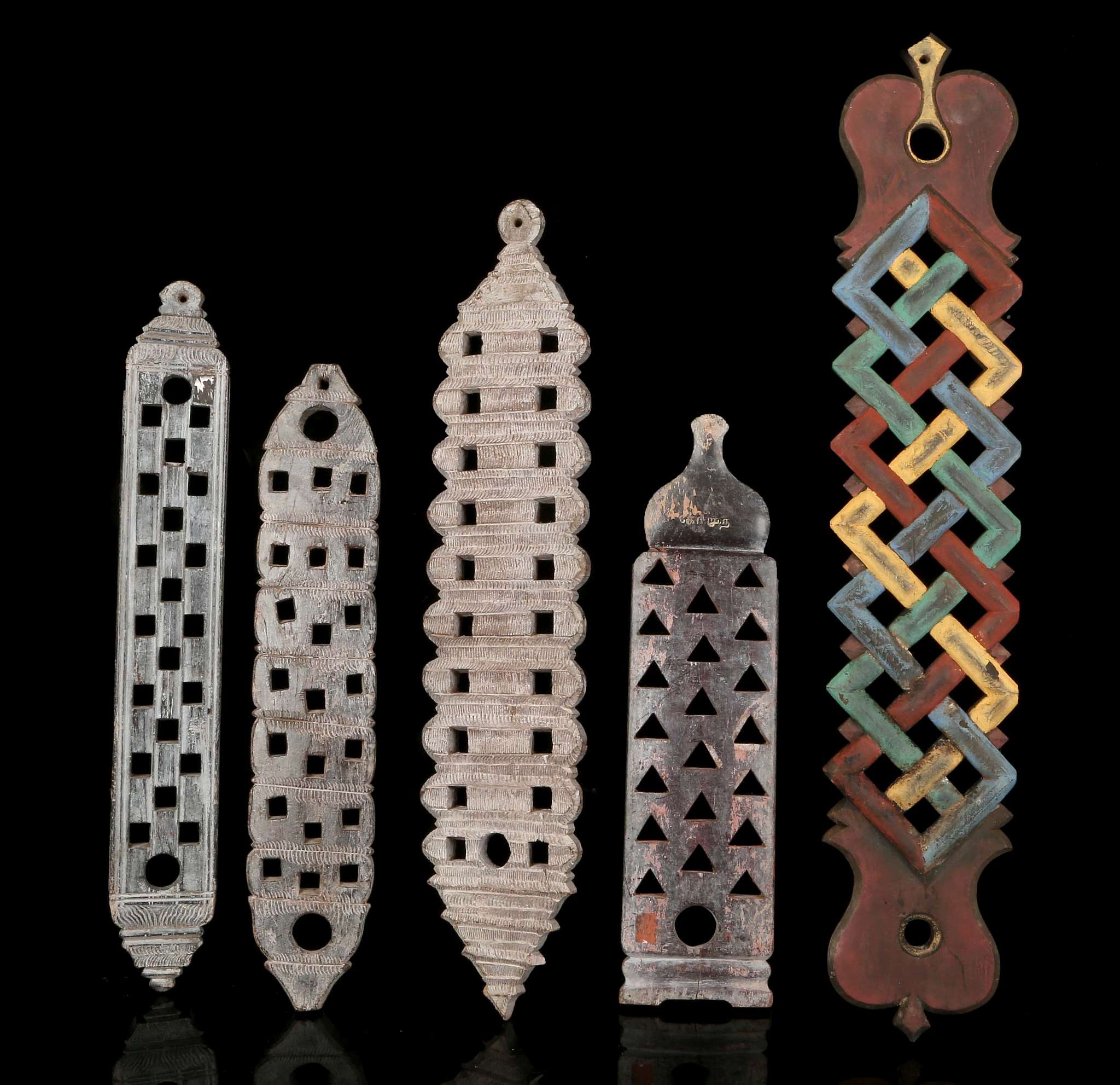 FIVE WOOD SPOON RACKS, SRI LANKA The four trays of rectangular shape, with openwork patterns to hold