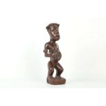 A KONGO VILI FIGURE, DEMOCRATIC REPUBLIC OF CONGO Standing with both hands holding the belly and the