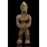 A MASK AND A BEADED FEMALE FIGURE, CAMEROON The mask covered in brass strips and decorated with