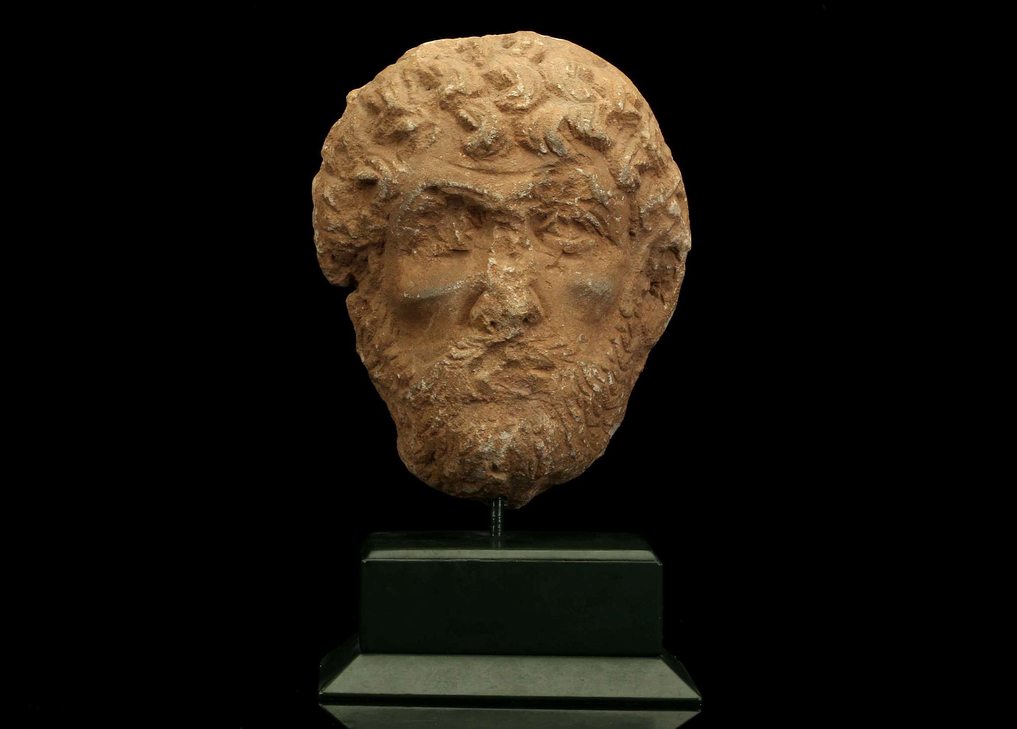 A ROMAN LIMESTONE MALE PORTRAIT HEAD Circa 2nd Century A.D. Possibly from a large relief, the back