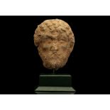 A ROMAN LIMESTONE MALE PORTRAIT HEAD Circa 2nd Century A.D. Possibly from a large relief, the back