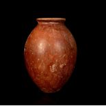 AN EGYPTIAN RED BURNISHED WARE JAR Pre-dynastic Period, Naqada I, circa 3500 B.C. The ovoid body