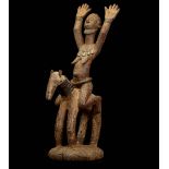 A DOGON HORSEMAN, MALI The nude female figure with both arms raised, 66cm high